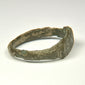 Rear view of ancient Roman bronze finger ring with irregular archaeological surface and surviving patina