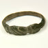 Late Antique bronze finger ring with solid cast hoop, expanding shoulders, and geometric incisions