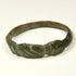 Side view of Late Roman bronze ring showing geometric shoulder grooves and worn archaeological surface