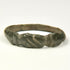 Ancient bronze finger ring with three diagonal engraved lines across the flattened front bezel
