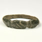 Ancient bronze finger ring with three diagonal engraved lines across the flattened front bezel