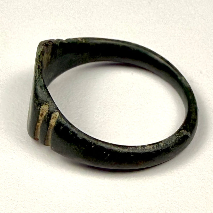 Ancient Roman bronze ring with substantial oval bezel, worn surface, and preserved archaeological patina