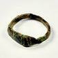 Roman Imperial bronze finger ring showing vertical grooves, diagonal incisions, and mineral deposits