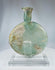 Roman archaeological glass flask showing iridescence, surface encrustation, and historic repairs