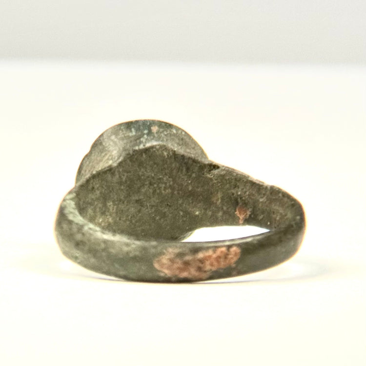 Front angled view of Roman–Byzantine bronze ring with heavily worn plain bezel and preserved ancient surface