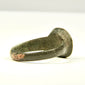 Close-up of ancient bronze finger ring bezel showing surface abrasion, pitting, mineral deposits, and olive-brown patina