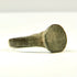Front view of Roman–Byzantine bronze ring showing broad worn circular bezel and tapered shoulders, US size 8