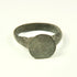 Roman to Early Byzantine bronze ring, US size 8, with broad circular bezel and intact tapered hoop, circa 1st–8th century CE