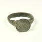 Roman to Early Byzantine bronze ring, US size 8, with broad circular bezel and intact tapered hoop, circa 1st–8th century CE