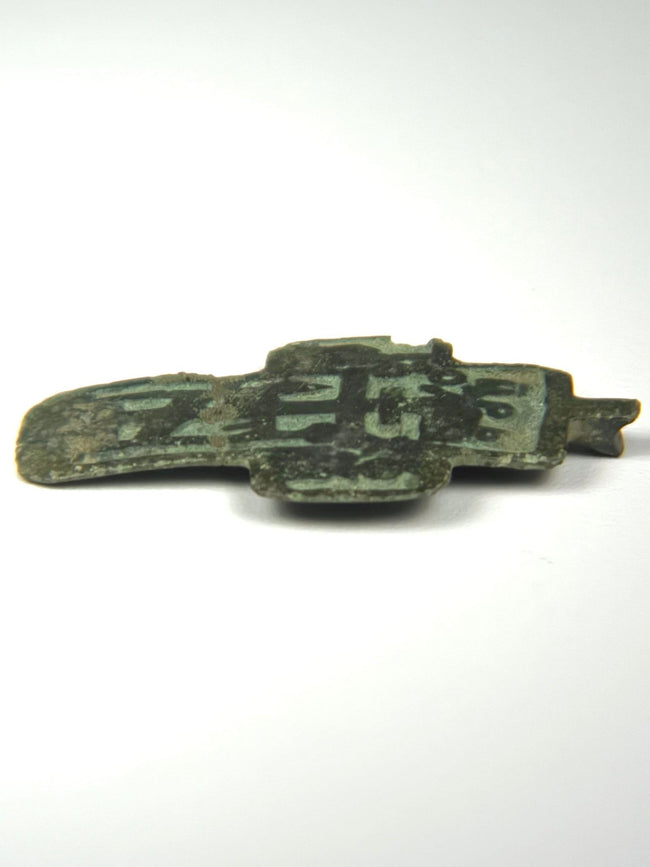 Small Orthodox devotional cross from Russia with champlevé enamel recesses, Cyrillic lettering, and earthen surface deposits, c. 1780–1820.