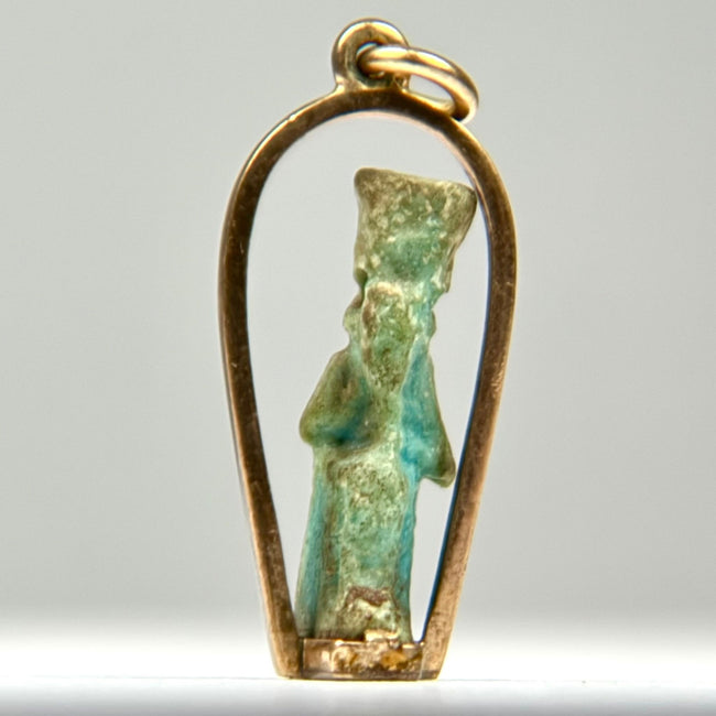 Ancient Egyptian blue-green faience amulet depicting a stylized standing divine figure, mounted in a later gold pendant setting, circa 664–30 BCE.