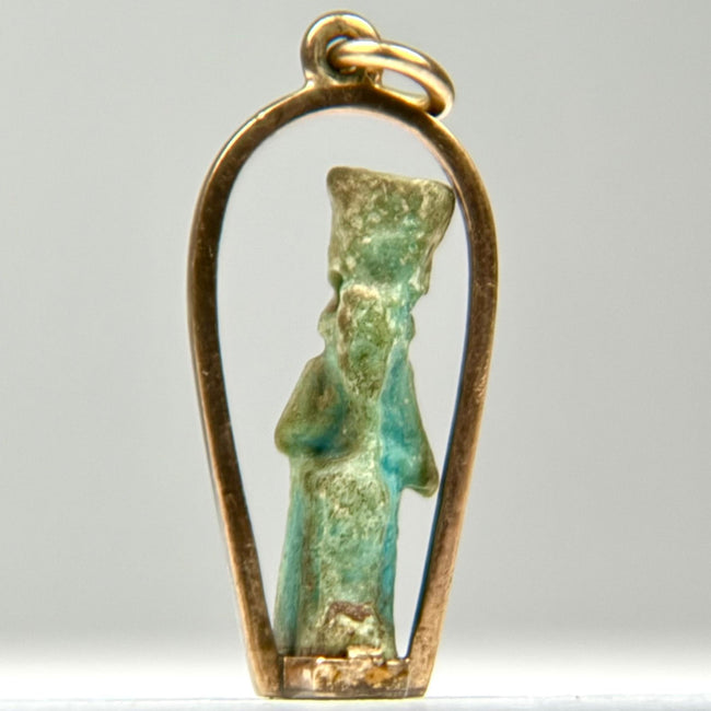 Small Ancient Egyptian faience deity amulet with turquoise glaze remains, mineral deposits, and a later custom gold pendant mount.