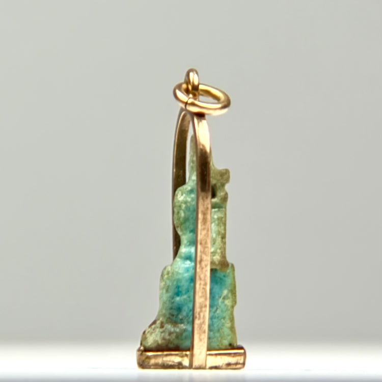 Ancient Egyptian protective amulet in glazed faience, dating circa 664–30 BCE, securely mounted within a later gold pendant setting.