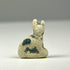 Ancient Egyptian faience cat amulet representing Bastet, with seated form and traces of blue-green glaze, circa 600–200 BCE.