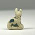 Small Ancient Egyptian Bastet cat amulet in faience with worn blue-green glaze and age-related surface encrustations.