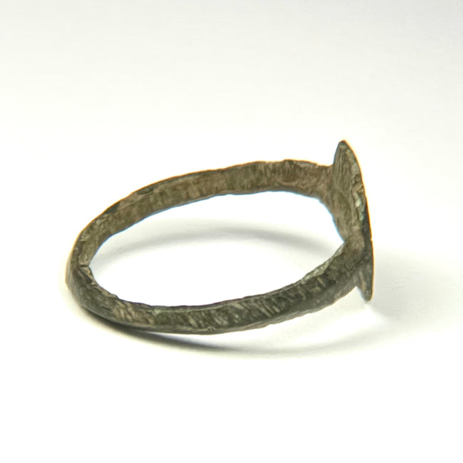 Early Byzantine bronze ring with geometric starburst motif and hand-cut decorative lines around the band