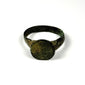 Ancient Roman-Byzantine bronze ring viewed from the side, showing broad shoulders, worn bezel, and naturally aged green patina
