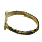 Side view of ancient bronze ring showing narrow hoop with repeated oblique incised decoration