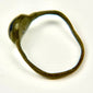 Angled view of ancient Roman bronze ring with blue cabochon and naturally aged patina