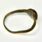 Close detail of blue glass cabochon mounted in an ancient bronze Roman ring bezel
