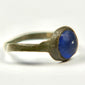Ancient Roman bronze jewelry ring with deep blue glass inset and narrow tapered shoulders