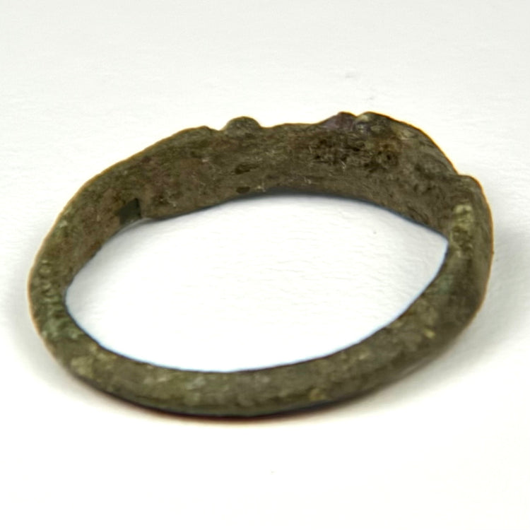 Close-up of Roman bronze ring bezel with surviving incised linear palm motif and surface oxidation