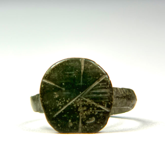 Front view of Late Roman bronze signet ring showing incised cruciform and geometric bezel decoration
