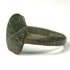 Close-up of Byzantine bronze signet ring with weathered incised cruciform bezel and naturally aged surface