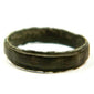 Ancient broad bronze finger band with raised rim detail and dark archaeological patina, Roman to Early Byzantine period