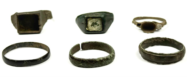 Six ancient bronze finger rings including square bezel, inset, round bezel and plain band forms from the Roman and Byzantine periods
