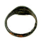 Close-up of Roman Imperial bronze finger ring showing smooth bezel surface and mineral deposits