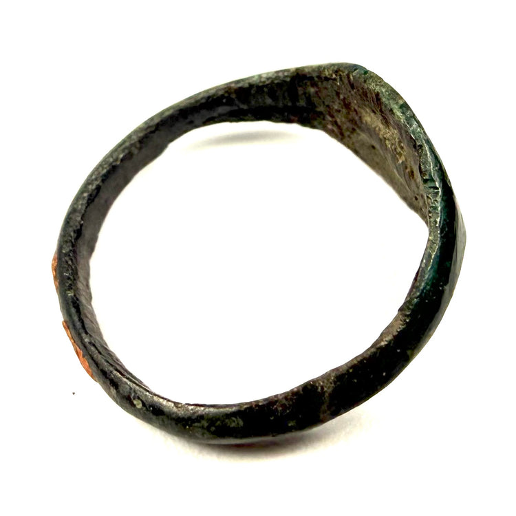 Ancient Roman jewelry ring in bronze with broad oval face and weathered archaeological surface
