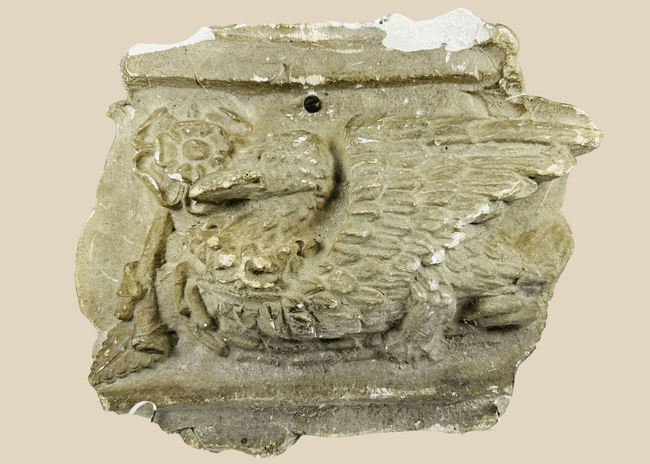Early 20th-century plaster relief of a medieval griffin with wings, referencing Westminster Coronation 1902