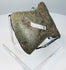 Angled view of an ancient Andean notched axe showing its rounded cutting edge, surface patina, and evidence of repeated sharpening.