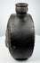 Pre-Columbian ceramic flask with stepped border surrounding a modeled face