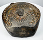 Ancient Peruvian blackware vessel with circular body and prominent loop handle