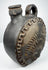 Blackware pottery canteen with integrated handle and anthropomorphic relief