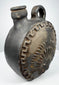 Blackware pottery canteen with integrated handle and anthropomorphic relief
