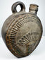 Pre-Columbian Andean flask with abstract relief motifs and worn ceramic surface