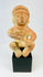 Pre-Columbian seated terracotta figure from West Mexico (Nayarit/Jalisco), circa 300 BCE–300 CE, hand-molded with red slip, stylized anthropomorphic features, burnished surface, shaft tomb funerary artifact on black display stand