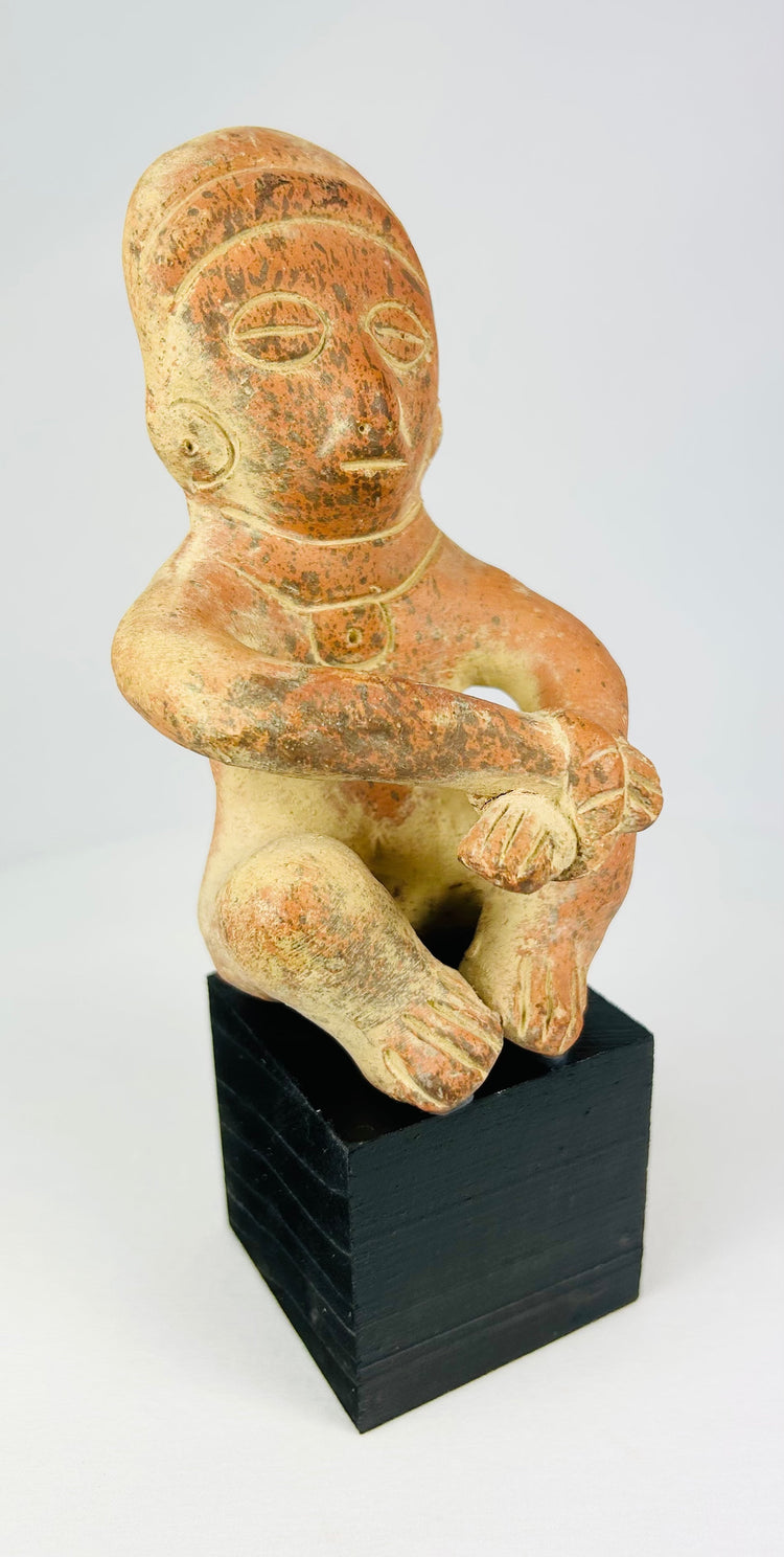 Seated terracotta figure from West Mexico, Nayarit/Jalisco, 300 BCE–300 CE, hand-molded with red slip