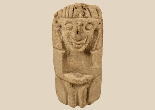 Pre-Columbian carved stone idol with stylized human face and almond eyes
