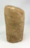 Pre-Columbian stone ritual figure with almond-shaped eyes and schematic facial features