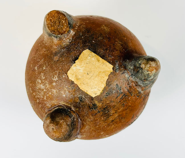 Ancient ceramic tripod vessel with sculptural face and ritual-style design
