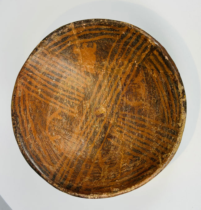 Pre-Columbian painted ceramic bowl with geometric designs and worn surface decoration