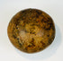 Ancient rounded ceramic container used for storage or ritual offerings with aged surface