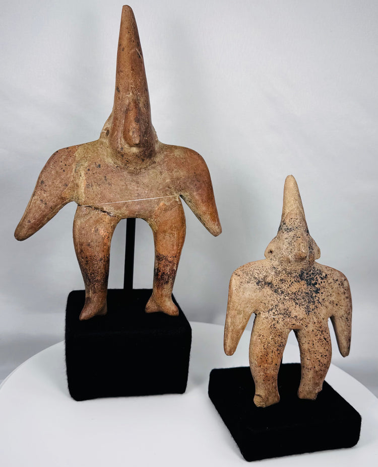 Close-up of larger Ancient Colima Gingerbread terracotta figure with elongated head and restored surface