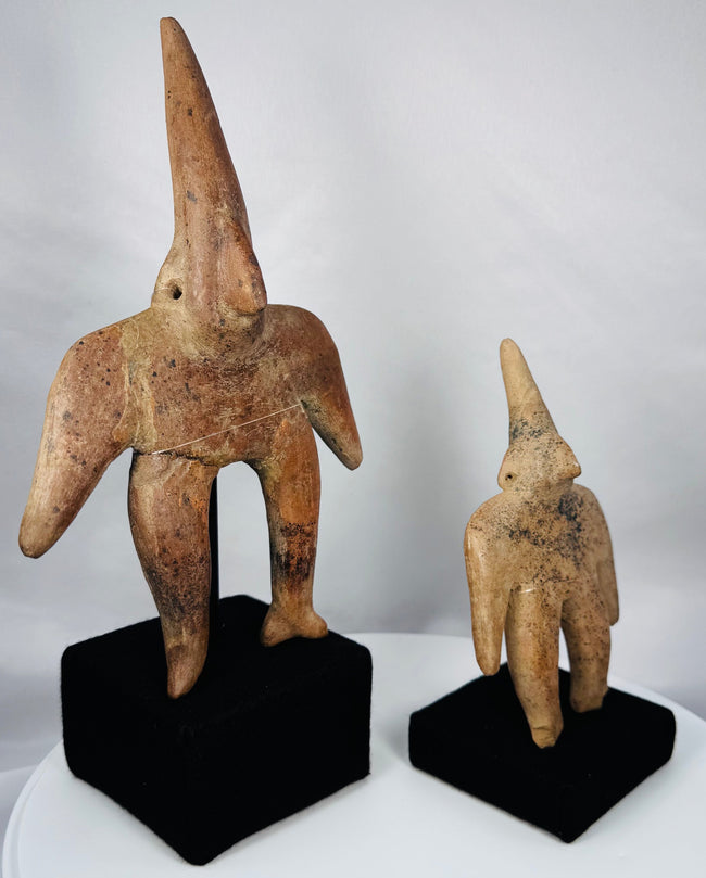 Ancient Colima terracotta figures displayed together on custom museum mounts