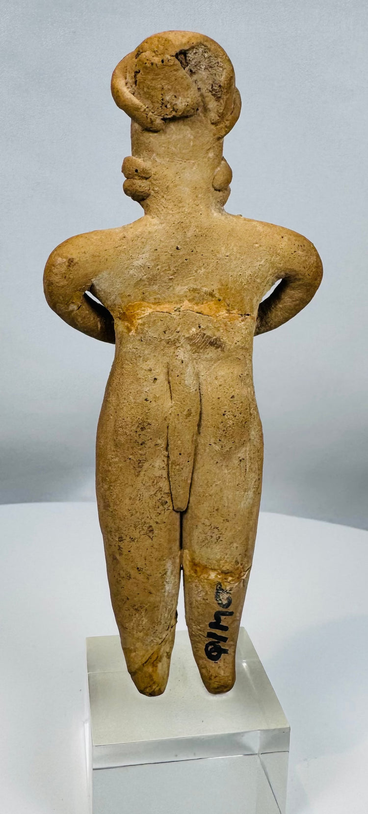 Pre-Columbian West Mexican terracotta female effigy with prominent ear ornaments and stylized facial features.