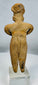 Pre-Columbian West Mexican terracotta female effigy with prominent ear ornaments and stylized facial features.